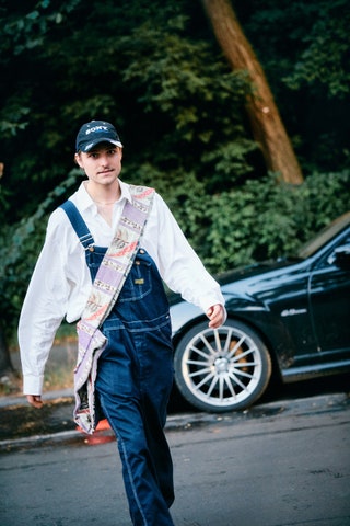 Image may contain Clothing Pants Jeans Person Teen Car Transportation Vehicle Machine Spoke and Alloy Wheel