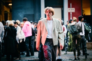 Image may contain Person Walking Clothing Coat Adult People Jacket Accessories Jewelry Necklace Head and Face