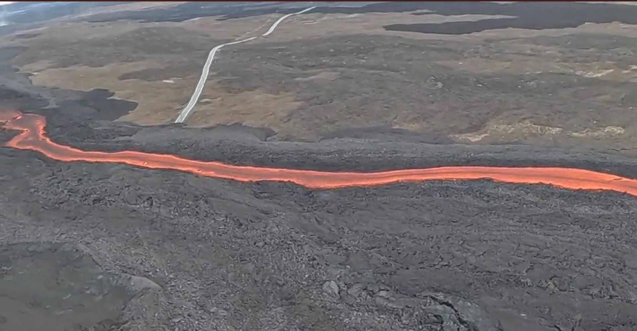 Helicopter view of the Mauna Loa lava flow over the access road.